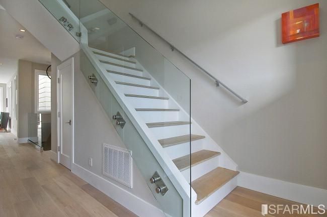 picture of the hallway remodeled with glass walled stairs